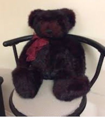 Gund teddy bear sitting in chair