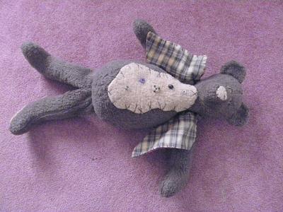 front view of old grey teddy bear