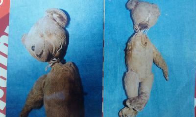 two very old and damaged teddy bears