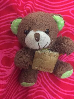 small teddy bear with green ears