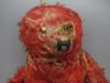 Very threadbare red teddy bear