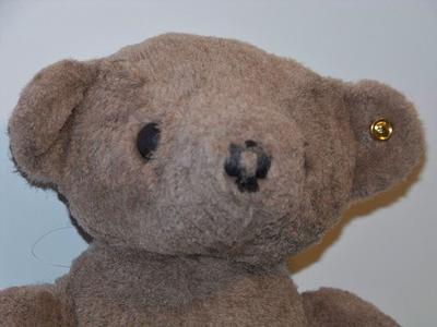Jointed bear with button in ear