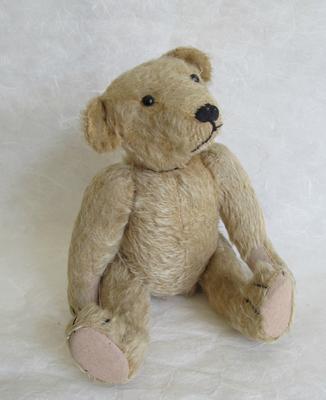 Sitting old teddy bear